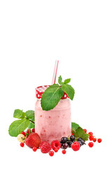 Mug smoothies and ripe berries on a white background.