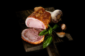 Rolled roasted pork meat on a cutting board