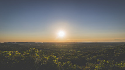 The sun setting over the countryside, panoramic landscape.