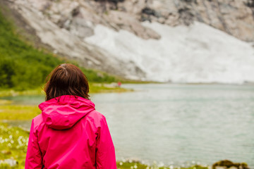 Tourist woman enjoying mountains landscape in Norway.