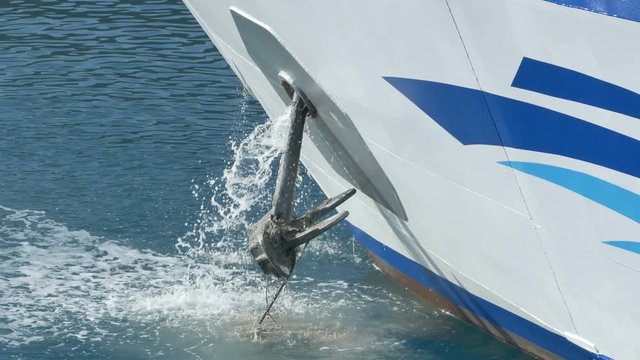 Large ship is lifitng the anchor.