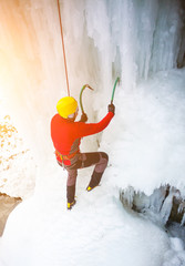 The climber climbs on ice.