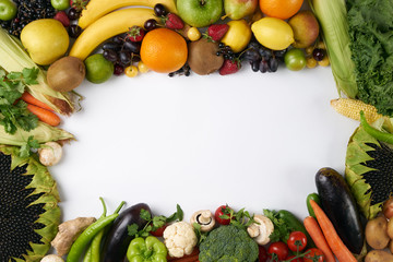 Top view of a rainbow colored fruit and vegetables on a white background with copy space. Juice and smoothie ingredients. Healthy eating / diet concept. Detox, vegetarian food.