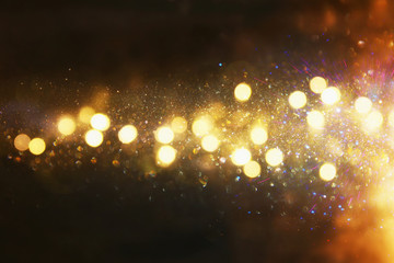 Obraz na płótnie Canvas glitter vintage lights background. gold and black. defocused