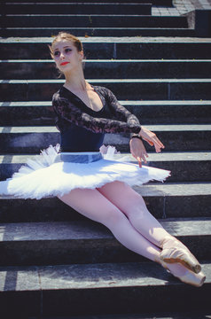 Young beautiful ballerina in city at sunny day, dancing and give a positive and inspiration for other people
