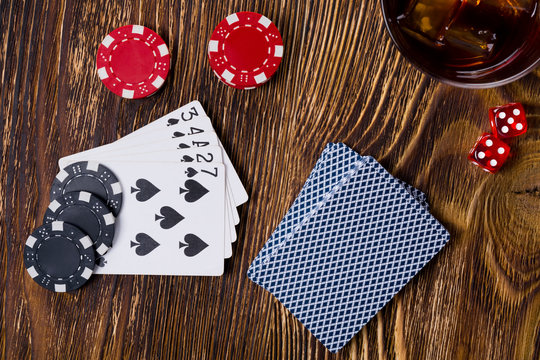 Big game of poker and dice on a wooden background