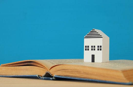 small house model over open book. selective focus