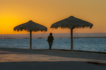 womamn enjoying the sunset in la paz baja california sur mexico