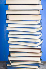 Stack of books on a blue background.