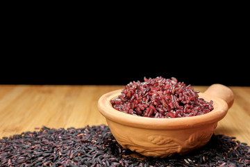 Cooked purple rice berry in clay pot