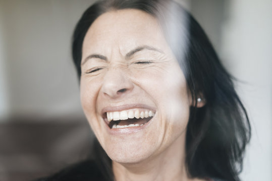 Portrait Of Laughing Woman With Eyes Closed