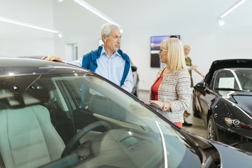 Couple looking at car in dealership