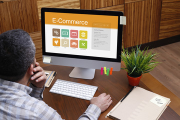 Fototapeta na wymiar Man using computer with E-Commerce concept on screen