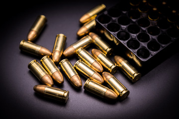 9 mm full metal jacket bullet on black background