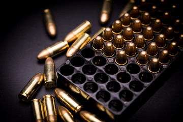9 mm full metal jacket bullet on black background