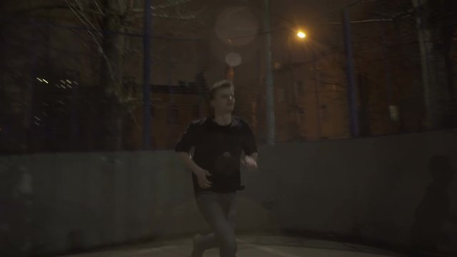 Young guy running around at night