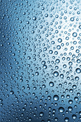 Water drops on surface, abstract blue background