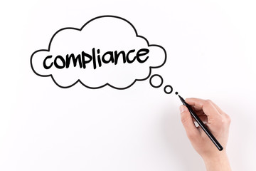 Hand writing Compliance on white paper, View from above
