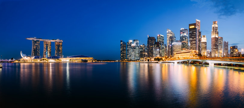 Panoramic photograph of Singapore skyline at night. Central Business District, Fullerton Park at the newly built Jubilee Bridge.