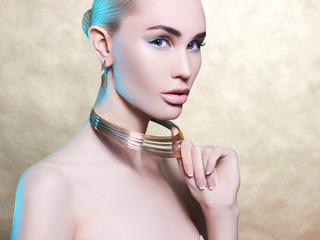 .Fashionable model on a gold, cold background.