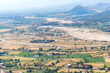 Aerial sunset view at old city village, fields and green mountains in Greece, Corfu