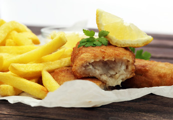 traditional British fish and chips on wooden background