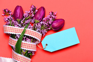 Tulips and lilac flowers in bunch with blue price label