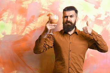 Brutal caucasian hipster holding tropical alcoholic fresh cocktail