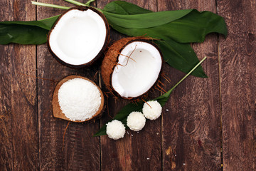 Tasty candies in coconut flakes on plate