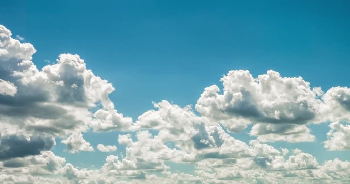 Time lapse clip of white fluffy curly rolling clouds