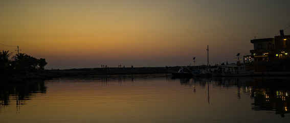 Romantic sunset in a harbor of Crete
