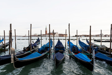 Fototapeta na wymiar Row of gondolas in Venice laguna, Italy