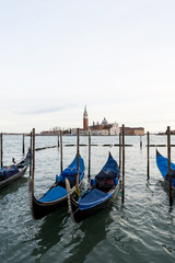 Row of gondolas in Venice laguna, Italy