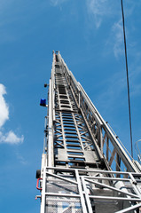 A tall fire escape ladder to the sky