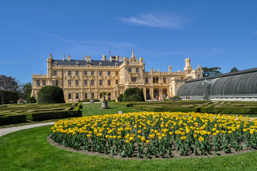 Fototapeta premium Chateau Lednice, Czech Republic. A beautiful castle with a garden and yellow flowers