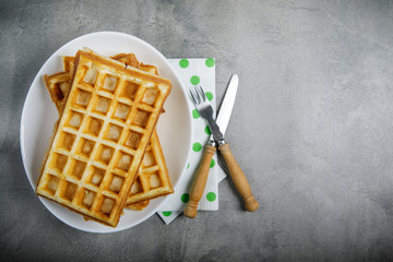 Freshly baked belgium waffles in plate with copy space. From top view