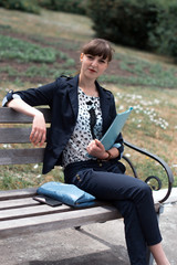 Business lady in a business suit with a small bag.