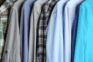Men's shirts on hangers, blue, gray and checkered