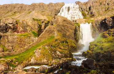 Nice summer view of Dynjandifoss (Dynjandi Waterfall), jewels of the Westfjords, Iceland. The biggest waterfall in Westfjords.