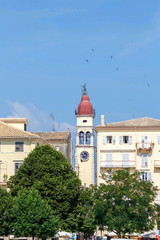 Old Byzantine clock tower on city background. Greece, Corfu