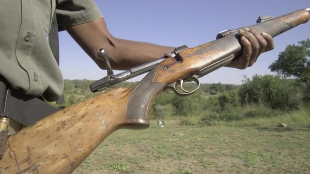 Black ranger loading bullets into his rifle.