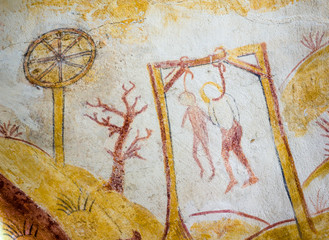 two persons hanging in the gallows, ancient medieval fresco