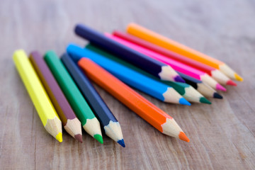 Selective focus of pencil colors on wood table
