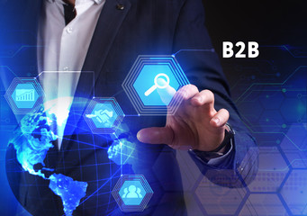 The concept of business, technology, the Internet and the network. A young entrepreneur working on a virtual screen of the future and sees the inscription: B2B