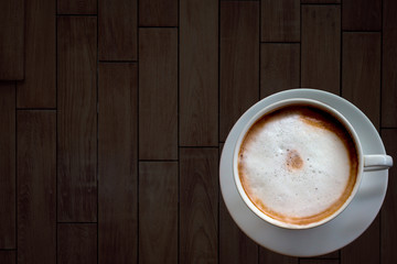 Hot coffee in white cup put on wood background from top view | Morning drink or break time.