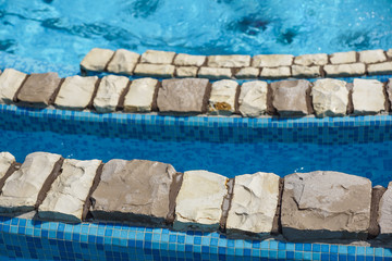 swimming pool blue water detail in summer time