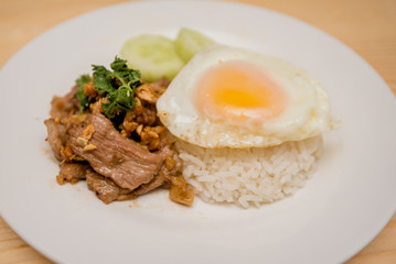 Pork fried garlic with rice and fried egg, Thai food