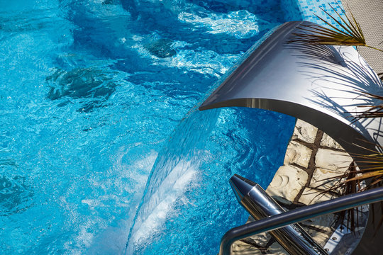 Swimming pool with fountain at hotel close up © steuccio79