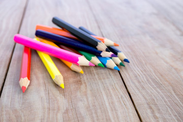 Selective focus of pencil colors on wood table