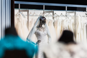 The mannequin looking as liquid terminator, in a beautiful wedding attire of the bride, shining the polished metal.
